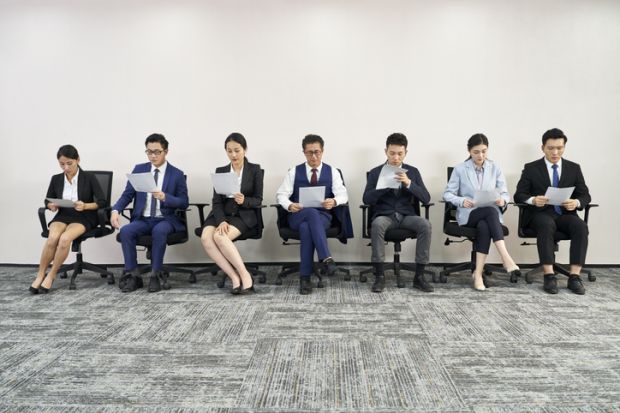 group of asian business people men and women waiting in line for job interview