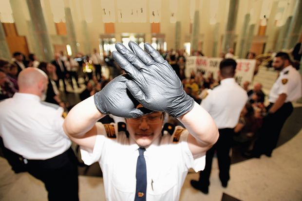 Security guard holds up hands
