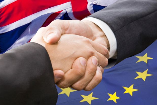 Handshake in front of European Union and United Kingdom flags