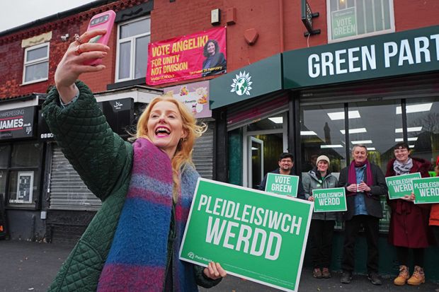 Green Party candidate Hannah Spencer takes a selfie with supporters outside the campaign headquarters on 18 February, 2026 at the Green Party offices in the Gorton area of Manchester, England.