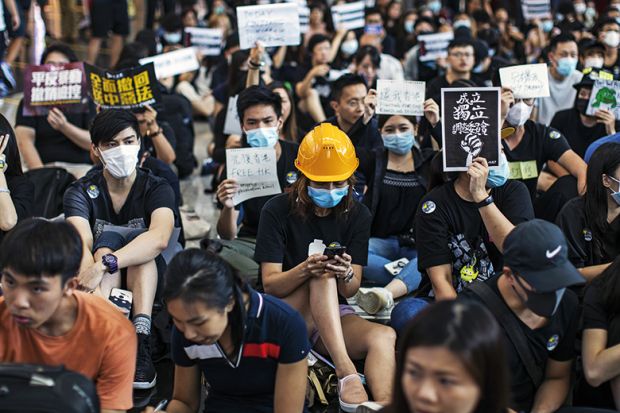Woman in hard hat amid Hong Kong protest
