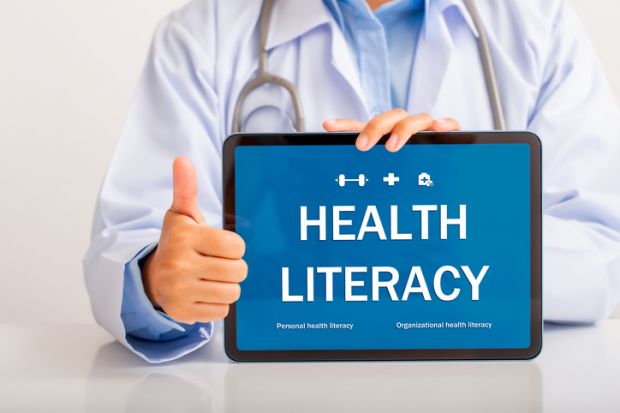 A doctor holding a "health literacy" sign A doctor holding a "health literacy" sign