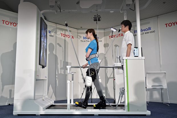 A model demonstrates how the rehabilitation-assist robot Welwalk WW-1000, developed by Japan’s Toyota Motor Corporation