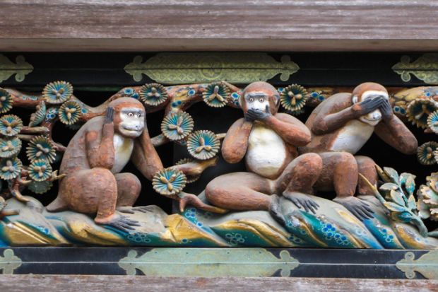Monkeys in the "hear no evil" pose