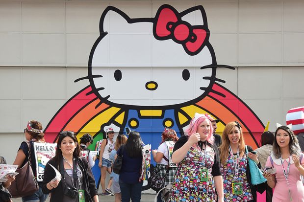 Hello Kitty mural with people in a group of people in front of it