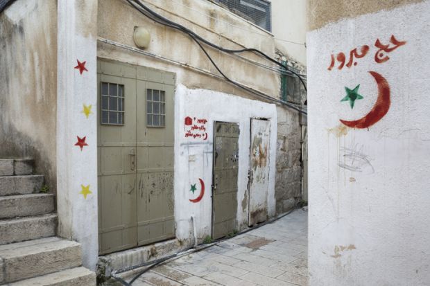 Horizontal view of some Arabic graffiti on the Muslim Quarter streets of the Old City of Jerusalem