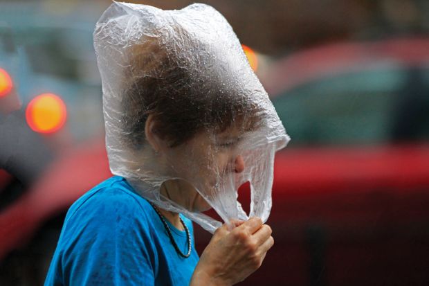 Hungarian woman wearing a plastic bag in the rain