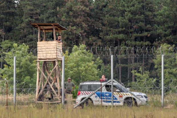  September 10, 2016: Hungarian policemen watching the Serbia Hungarian border fence