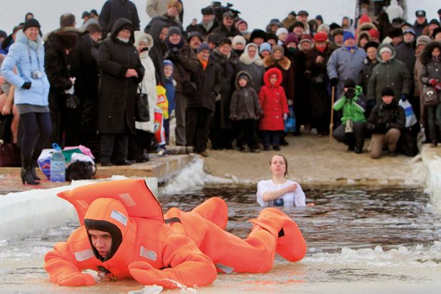 A rescue worker exits the icy waters of the Dnepr River in Kiev during an Orthodox Epiphany celebration A rescue worker exits the icy waters of the Dnepr River in Kiev during an Orthodox Epiphany celebration