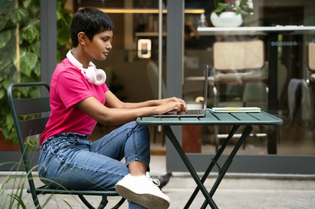 An Indian student or entrepreneur works on her laptop