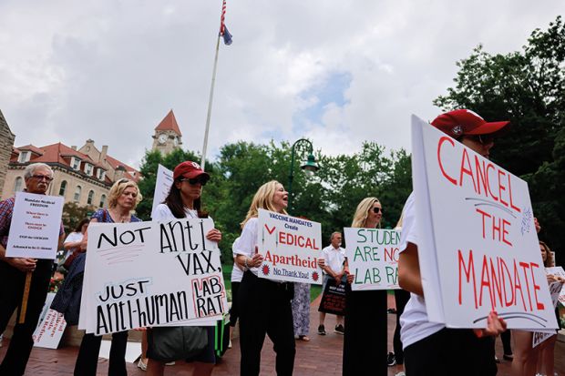 Anti-vaxxers and anti-maskers gathered at Indiana University’s Sample Gates to protest against mandatory Covid vaccinations Anti-vaxxers and anti-maskers gathered at Indiana University’s Sample Gates to protest against mandatory Covid vaccinations