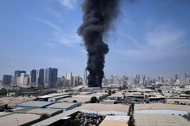A black plume of smoke rises from a warehouse at the industrial area of Sharjah City in the United Arab Emirates following reports of Iranian strikes in Dubai, United Arab Emirates, Sunday, 1 March, 2026.