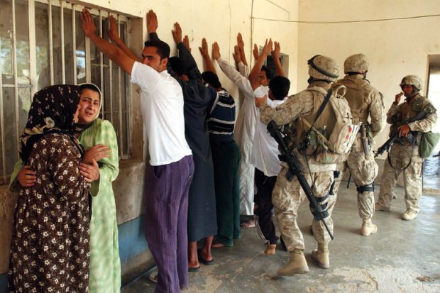 Iraqi family stand detained by US Marines Iraqi family stand detained by US Marines