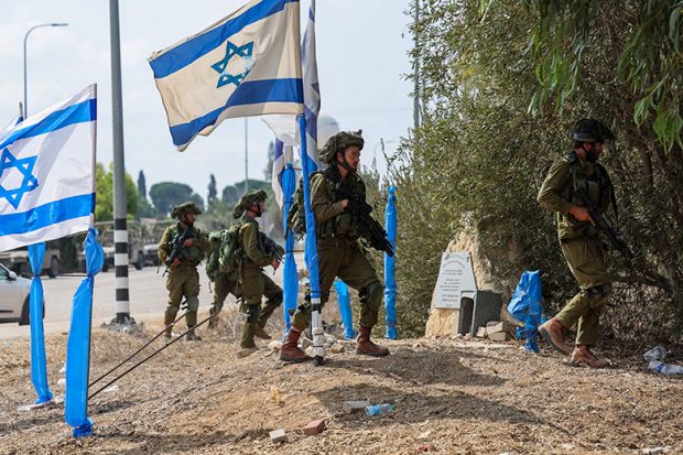 Israeli soldiers patrol an area in Kfar Aza, south of Israel bordering Gaza Strip, on October 10, 2023.
