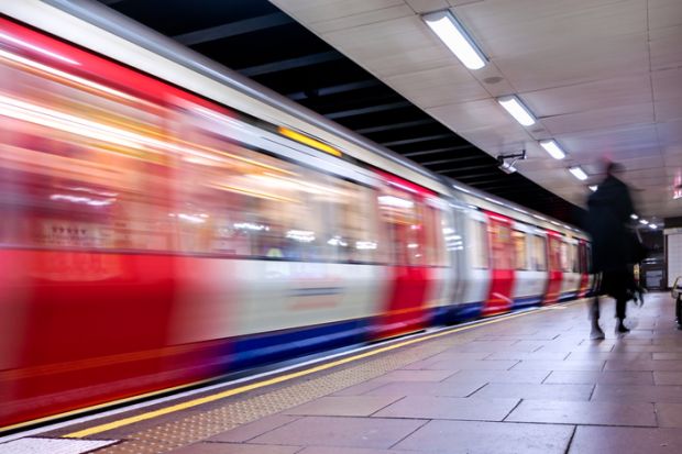 A London Underground train speeds through a station. Lack of commute is a factor in academics reporting satisfaction with homeworking.