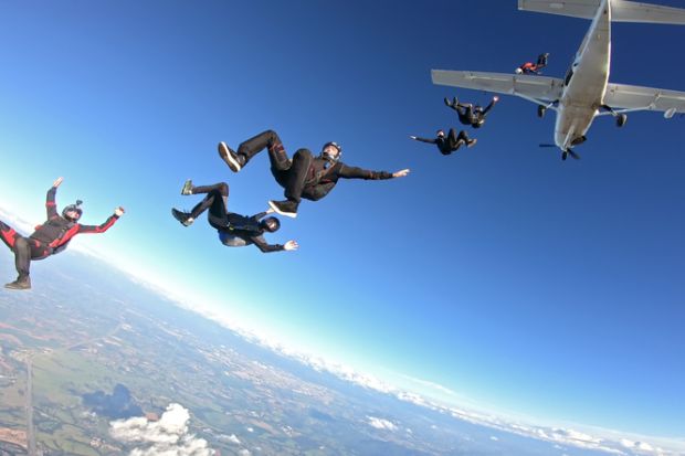 Group of skydivers having fun at the skies