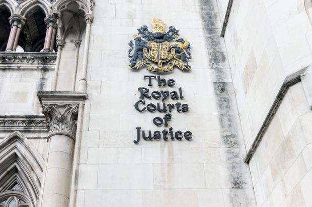 rest on the wall of Royal Courts of Justice on the Strand in central London rest on the wall of Royal Courts of Justice on the Strand in central London