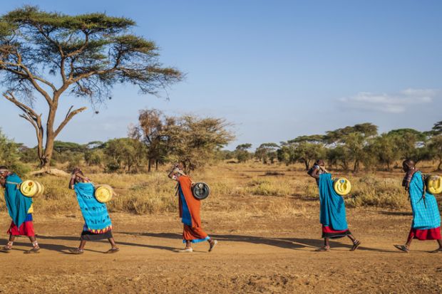 Maasai women carrying water