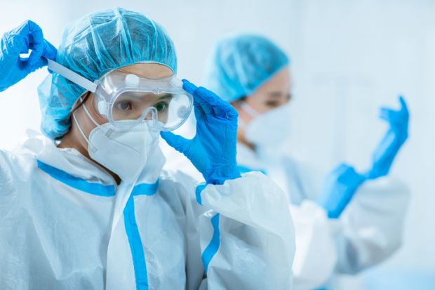 Doctors wear protective suits