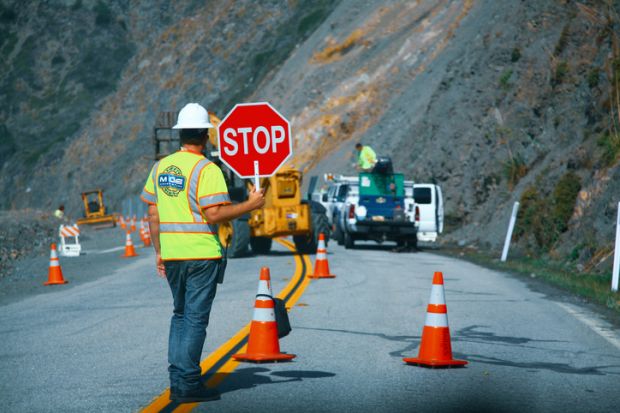 Road workers repairing the Highway #1 at the US West Coast Road workers repairing the Highway #1 at the US West Coast