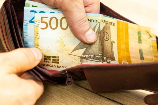 Open wallet with Norwegian kroner notes