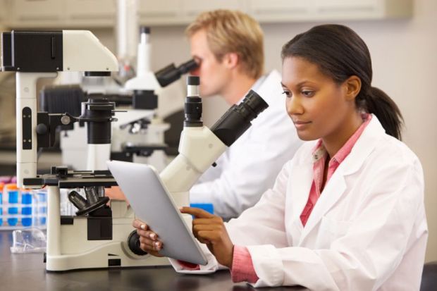 A black female scientist working in a lab
