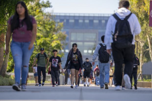 University students walk past the Natural Sciences and Mathematics build on the campus of Cal State University University students walk past the Natural Sciences and Mathematics build on the campus of Cal State University.