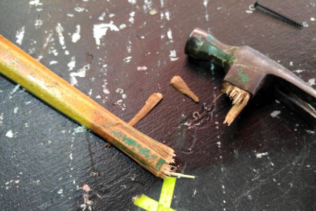 Close-Up Of Broken Hammer Handle On Table