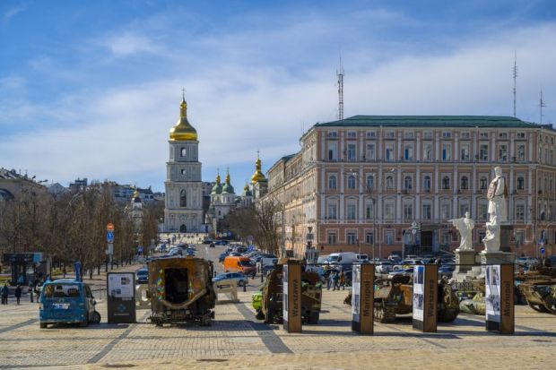 A destroyed vehicle near a cathedral in Ukraine 