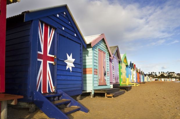 Closed beach huts with Australian flag