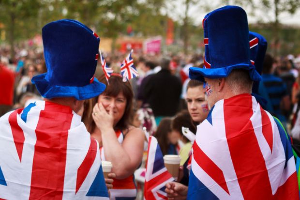 Unknown fans dressed in Union Jack flags and hats in the Olympic Park in Stratford, East London