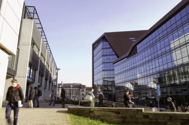 Students can be seen walking to and from the Roland Levinsky building at the University Of Plymouth in the city centre of Plymouth.