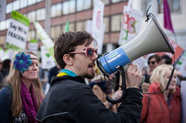A demonstrator uses a megaphone to call for an end to the use of fossil fuels A demonstrator uses a megaphone to call for an end to the use of fossil fuels