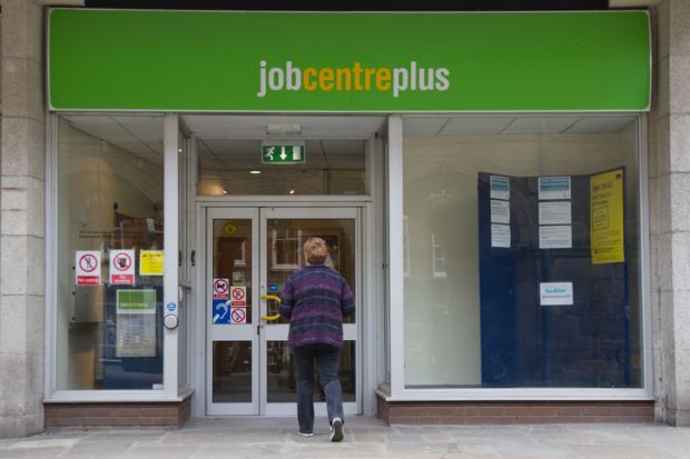 Woman walks towards door of Job Centre Plus in Shrewsbury town centre Shropshire. Woman walks towards door of Job Centre Plus in Shrewsbury town centre Shropshire
