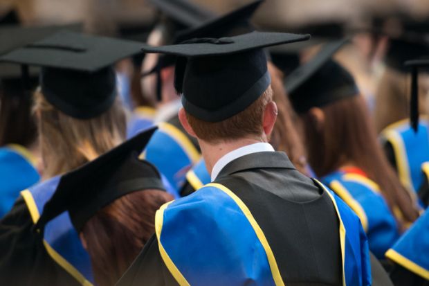  Students sit in a row at their university graduation ceremony.