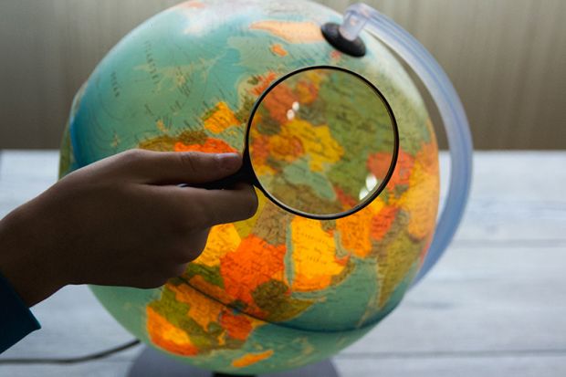 Globe under magnifying glass