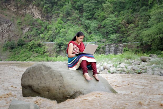 Indian woman in river with laptop Indian woman in river with laptop
