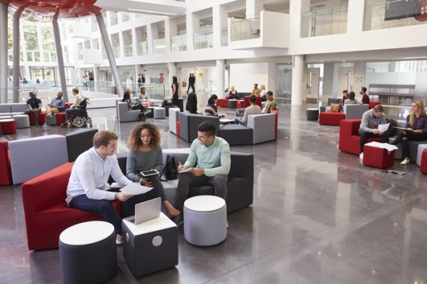 Students sitting in a university atrium Students sitting in a university atrium