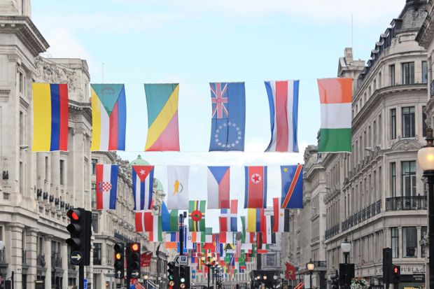 A number of different national flags are displayed above a London street A number of different national flags are displayed above a London street