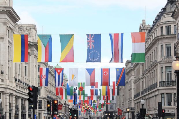 A number of different national flags are displayed above a London street