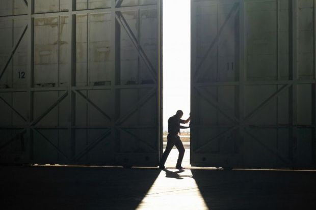 Man pushing door open