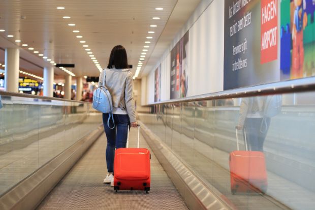 One girl with red suitcase in airport
