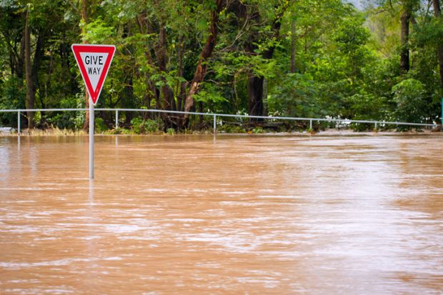 flood disaster Australia Give Way sign inundation