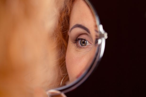 istock self-scrutiny A woman's eye reflected in a mirror