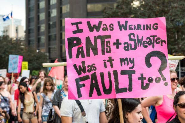 A protest sign reading "I was wearing pants + a sweater, was it my fault too?" Taken during "Slut Walk 2012" in Toronto.