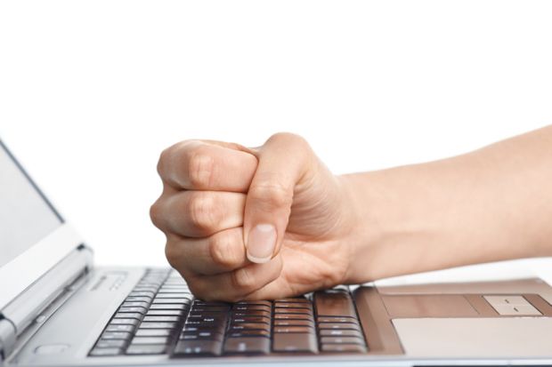Man hitting keyboard with fist