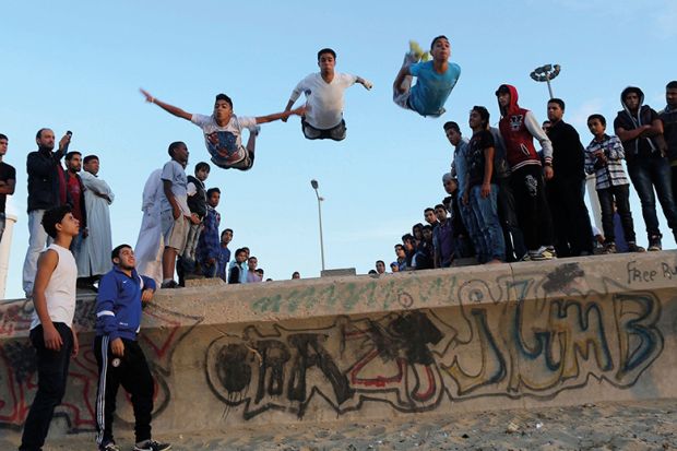  Young Libyans practise parkour on the beach in Benghazi
