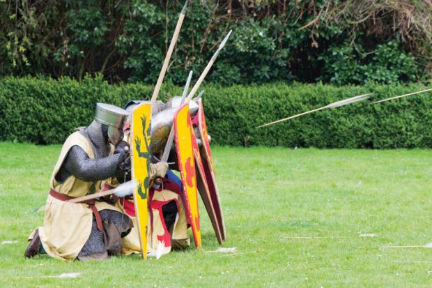 Knights seeking cover from arrows behind shields