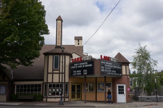 Lake Oswego, OR, USA - July 4, 2020: The cinema billboard at Lake Theater in downtown Lake Oswego shows the numbers of newly reported COVID-19 cases in Oregon.