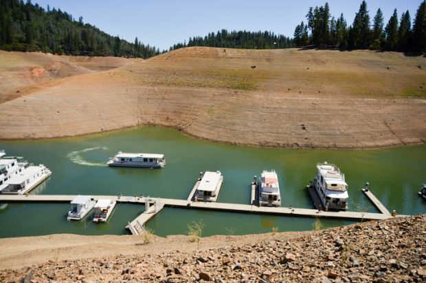 Lake Shasta, USA - August 17, 2014 California's lingering drought exposes the 180-200 foot drop in water levels. The state's largest reservoir is receding at an average of 4.9 inches per day. The 3-year-long drought is affecting tourism and boating recrea